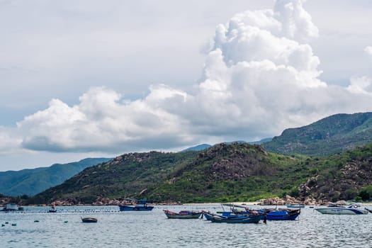 Beautiful sea landscape panorama. Green forested mountains island . Fishing boats near beach. Nature background. Tranquility calm ocean relax energy.