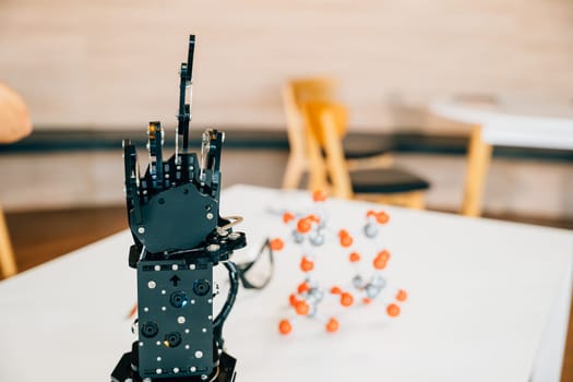Cyborg mechanical arm features a black real robot hand making contact on a table. Representing futuristic intelligence and technological development in industry.