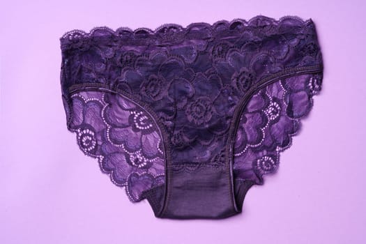 Women's panties on pink background with copy space flat lay