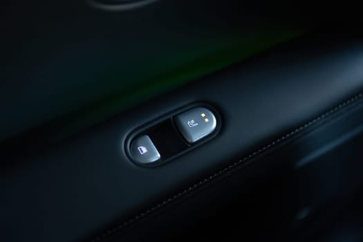 Rear passengers Seat heater button, car interior. Double seat heating switch in a car. Button for heating the rear of seats. Rear seat heated seat controls.