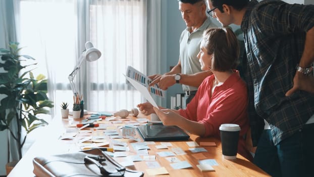 Smart project manager working together with businessman choosing logo design. Professional business team planning and discussing about marketing strategy while looking at color palettes. Symposium.