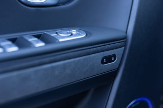 Control buttons for settings and memory of the driver's seat, electric glass opening, door handle in the interior of the new luxury electric car. Driver's seat adjustment buttons.