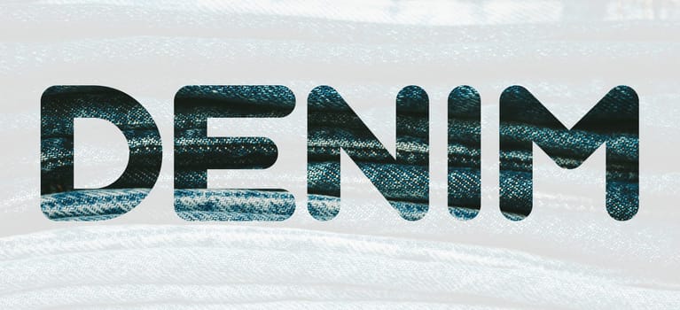 Word DENIM from denim blue pattern of folded jeans background. Fashion, stock and magazine concept. Denim font. High quality photo