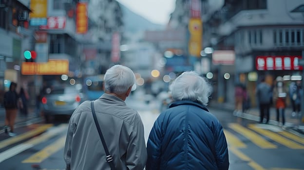 Two seniors strolling through the city, buildings towering above them, holding hands with hats on. Cars pass by on the asphalt road