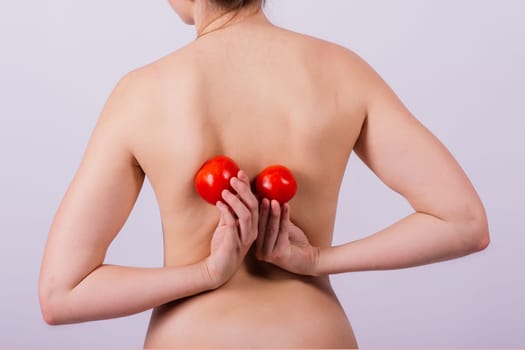 Female with tomatoes on chest and back, concept of healthy food and female health
