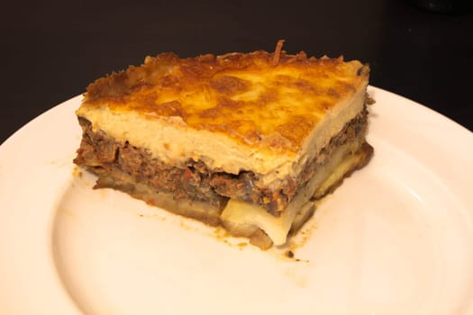 Indulge in the rich culinary tradition of the Mediterranean with this enticing plate of moussaka. Layers of tender eggplant, savory minced meat, and creamy bechamel sauce come together in a symphony of flavors and textures.