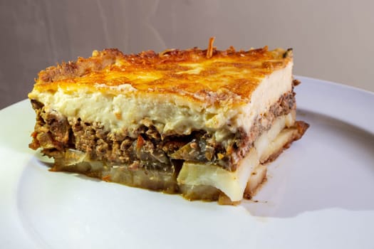 Indulge in the rich culinary tradition of the Mediterranean with this enticing plate of moussaka. Layers of tender eggplant, savory minced meat, and creamy bechamel sauce come together in a symphony of flavors and textures.