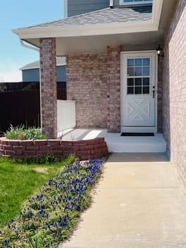 This image showcases the charming front yard of a suburban house, basking in the warm glow of sunlight, with well-manicured lawns and colorful flowers adding to its appeal.