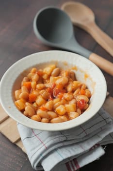 Tasty baked beans in a bowl on table ,