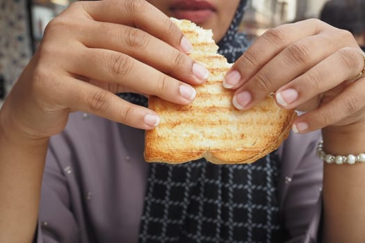 woman hand pick Sandwich with ham, cheese, tomatoes,,.