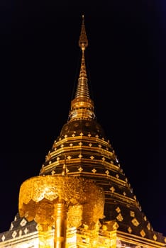 Chiang Mai, Thailand - January 8, 2022 : Wat Phra That Doi Suthep at night time is buddhist temple (wat) in Chiang Mai province. Within the site are pagodas, statues, bells, a museum, and shrines.