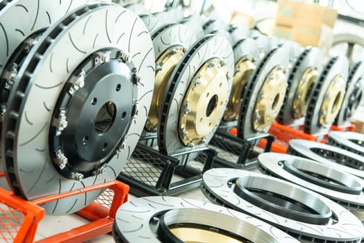 Bangkok, Thailand - February 4, 2023 : Unidentified car mechanic or serviceman disassembly and checking a disc brake and asbestos brake pads for fix and repair problem at car garage or repair shop