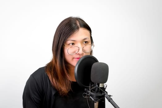 Beautiful asian woman (LGBTQ) is a singer. She enjoying sing a song or karaoke in music studio with microphone condenser and headphones for fun or voice creative