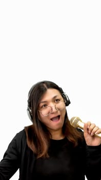 Beautiful asian woman (LGBTQ) is a singer. She enjoying sing a song or karaoke in music studio with microphone condenser and headphones for fun or voice creative