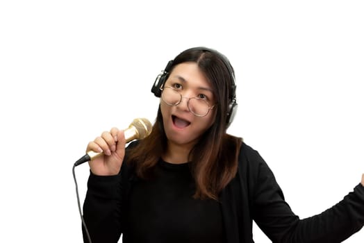 Beautiful asian woman (LGBTQ) is a singer. She enjoying sing a song or karaoke in music studio with microphone condenser and headphones for fun or voice creative