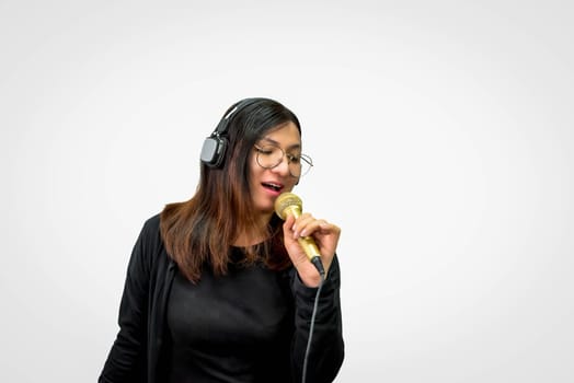 Beautiful asian woman (LGBTQ) is a singer. She enjoying sing a song or karaoke in music studio with microphone condenser and headphones for fun or voice creative