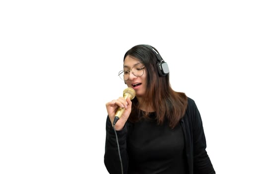 Beautiful asian woman (LGBTQ) is a singer. She enjoying sing a song or karaoke in music studio with microphone condenser and headphones for fun or voice creative