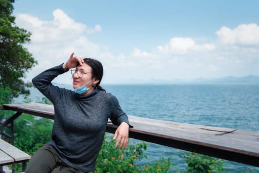 Beautiful asian woman (LGBTQ) natural makeup wear fashion relax clothes posing at sea viewpoint with happy and fun emotion in concept travel, vacation, leisure in life