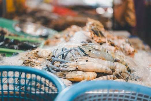 Fresh raw shrimp (Giant freshwater prawn) premium grade can cook to grilled shrimp by grilling with charcoal display for sale at Thai street food market or restaurant in Bangkok Thailand