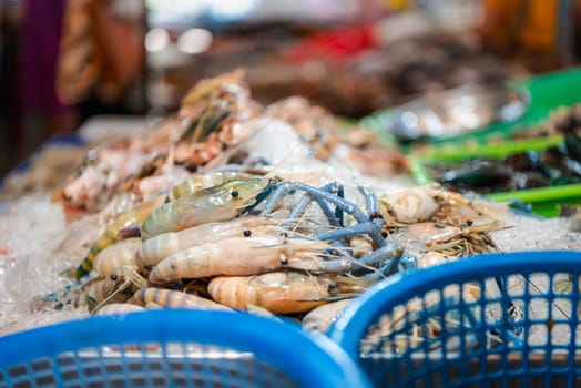 Fresh raw shrimp (Giant freshwater prawn) premium grade can cook to grilled shrimp by grilling with charcoal display for sale at Thai street food market or restaurant in Bangkok Thailand