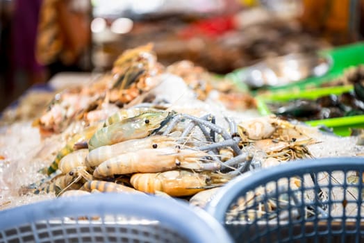 Fresh raw shrimp (Giant freshwater prawn) premium grade can cook to grilled shrimp by grilling with charcoal display for sale at Thai street food market or restaurant in Bangkok Thailand