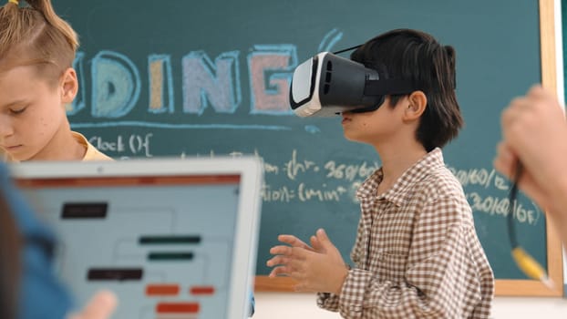 Energetic child wearing Vr headset while enter virtual world at classroom. Student programing system while generated AI to code engineering prompt software while boy fixing electronic board. Pedagogy.