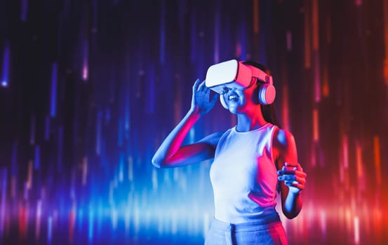 Smart female standing in cyberpunk style building in meta wear VR headset connecting metaverse, future cyberspace community technology, Elegant woman look far position of virtual world. Hallucination.