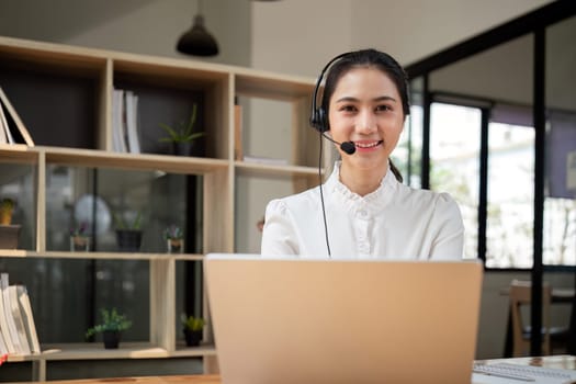 Call center friendly woman asian in office for customer service, technical support and advice, contact and communication with employee operator in help desk agency.