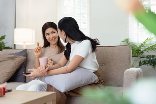 mature daughter and mother sitting together in the morning. mature daughter and retired mother spend weekend together.