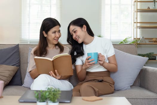 mature daughter and mother sitting together in the morning. mature daughter and retired mother spend weekend together.