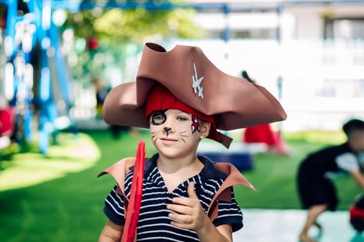 Boy Cat Pirate costume. Halloween party in kindergarten. Aqua makeup painted kids face. Bright festive.