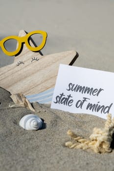 SUMMER STATE OF MIND text on paper greeting card on background of funny starfish in glasses summer vacation decor. Sandy beach sun coast. Holiday concept postcard. Getting away Travel Business concept