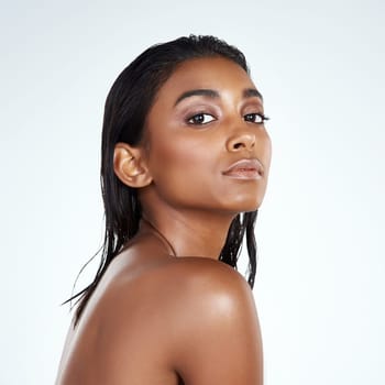 Studio, portrait and Indian woman with natural beauty from dermatology in mockup space. Face, skincare and girl with confidence from glow on skin or pride from healthy cosmetics in white background.