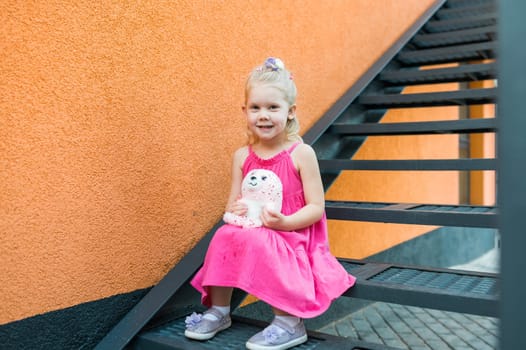 Child girl with hearing aids and cochlear implants having fun outdoor speak and playing. Copy space and empty place for advertising.