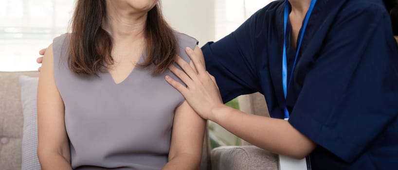 Doctor or caregiver woman holding elderly female patient hand cheer and encourage while checking health.