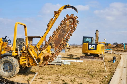 Busy Construction Site in Fort Wayne, Indiana: Power of Progress with Heavy-duty Machinery Building New Homes