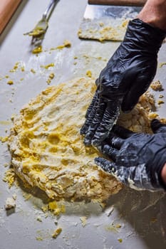 Professional hands kneading fresh pasta dough in a hygienic kitchen in Fort Wayne, Indiana - Capturing the artistry of food preparation