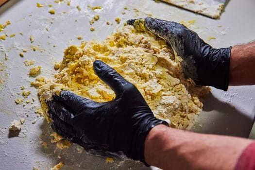 Professional Baker Handcrafting Fresh Pasta Dough in a Hygienic Kitchen in Fort Wayne, Indiana