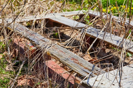 Leftover relics of rural decay in Spiceland, Indiana - weathered barnwood and old bricks amidst encroaching nature.