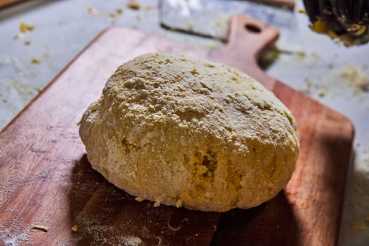 Whole grain bread dough on a flour-dusted wooden board, representing homemade cooking in Fort Wayne, Indiana.