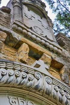 Daylight Highlights Craftsmanship on Historic Bishop Simon Brute College Stonework in Spring, a Testament to Indiana's Religious Heritage.