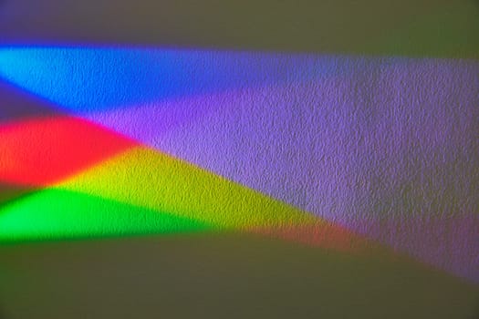 Vibrant Spectrum on Textured Wall in Fort Wayne - A display of color theory in action through a vivid rainbow refracted by a flashlight.