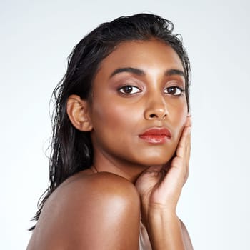 Studio, beauty and portrait of Indian woman with makeup and skincare in mockup space. Model, face and girl with confidence from healthy dermatology or pride from cosmetics in white background.