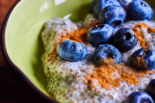 Close-up of delectable chia seed pudding with blueberries and cinnamon in rustic bowl, encapsulating healthy lifestyle in Fort Wayne, Indiana