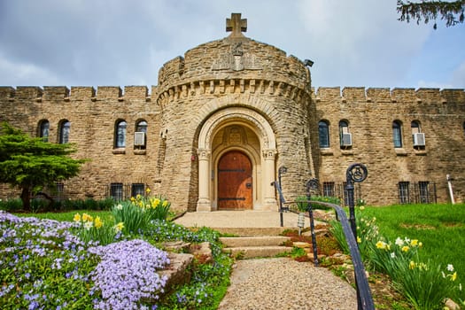 Spring blooms at the striking Bishop Simon Brute College in Indianapolis, showcasing its medieval-style architecture and Christian heritage