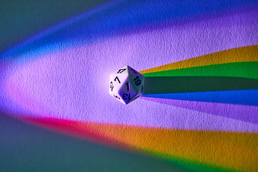 Vibrant macro shot of a floating D20 dice casting a shadow over a rainbow, depicting chance and the spectrum of outcomes in Fort Wayne, Indiana.