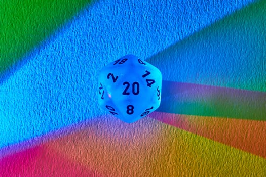 Dazzling rainbow spectrum illuminates a translucent twenty-sided die, symbolizing success and the vibrant world of fantasy gaming.