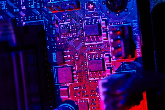 Macro shot of computer motherboard in striking blue and purple light, highlighting the intricacy of tech design in Fort Wayne, Indiana.