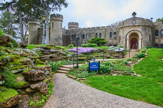 Spring at Bishop Simon Brute College, a vibrant castle-like seminary in Indianapolis, inviting guests with its lush gardens and medieval charm.