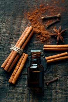 essential oil in a bottle and cinnamon. selective focus. nature.